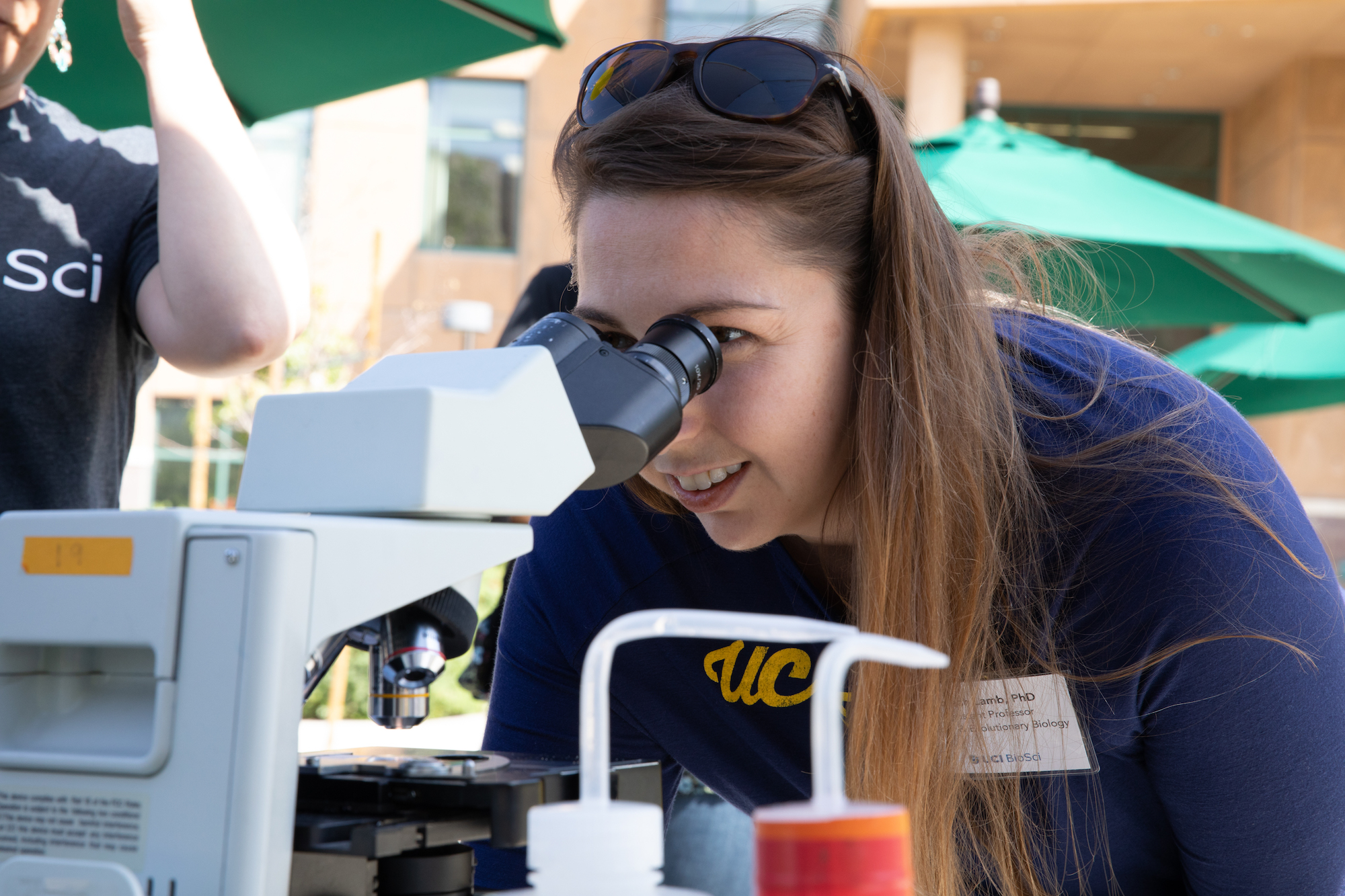 Student observing through microscope