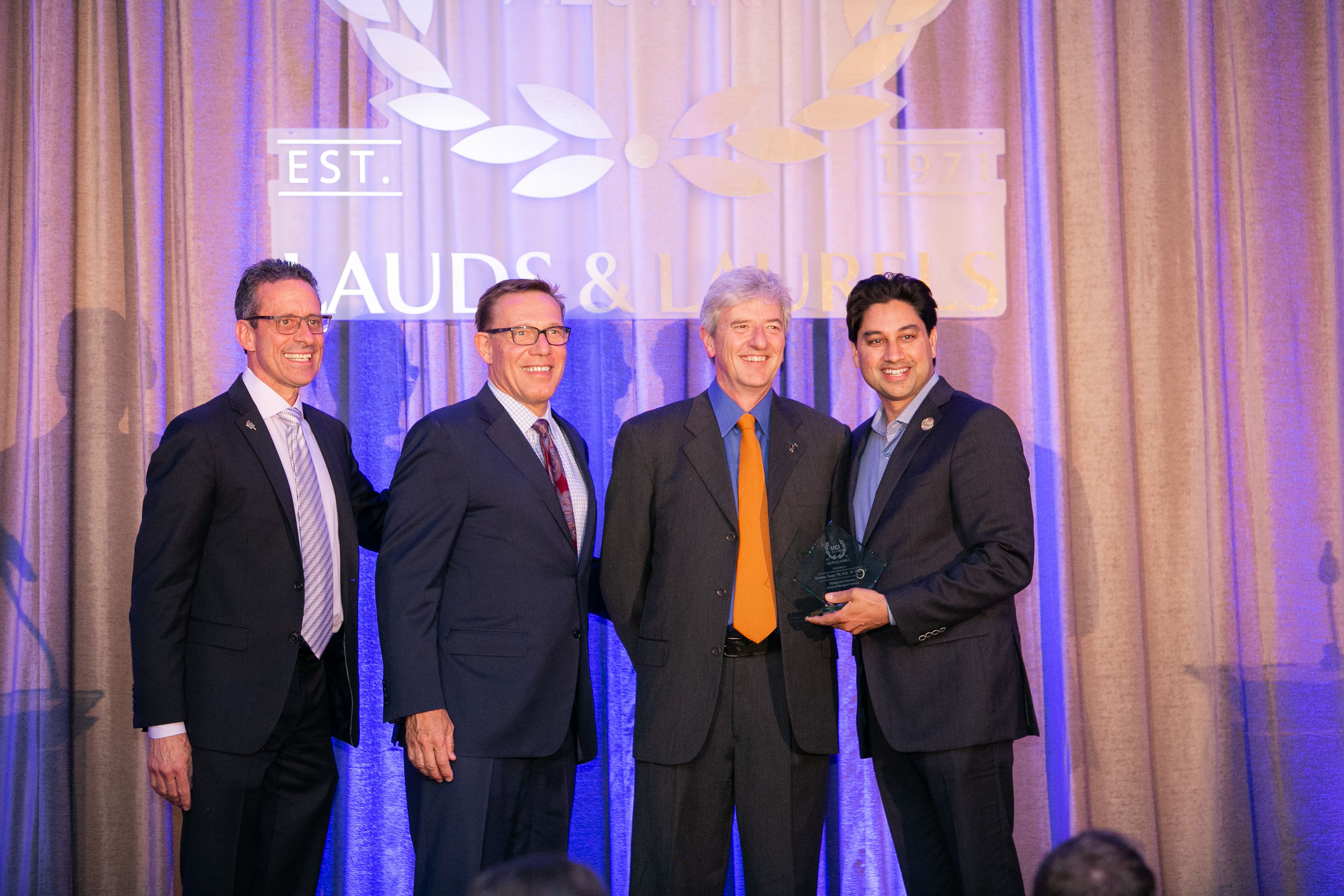 Dean Michael Stamos, Dean Eric Spangenberg, Professor Chris Hughes, and Devansu Tewari ’93, M.D. ’97, MBA ’14