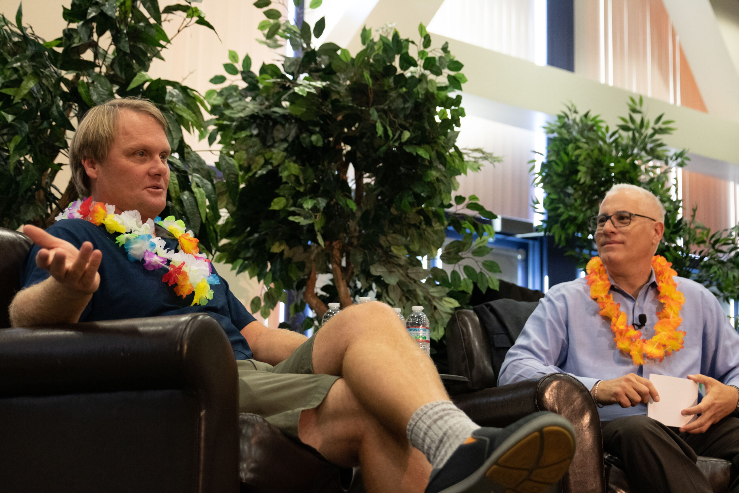 Picture of Biotech entrepreneur Charlie Dunlop sitting on a couch with a lei around his neck