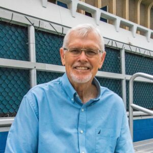 Professor James Hicks stands next to the Crawford pool at UC Irvine.