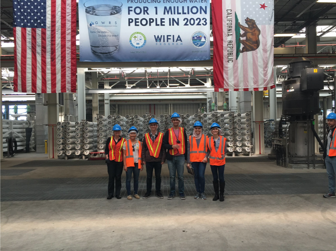 The Whiteson lab poses for a photo at a waste treatment plant.