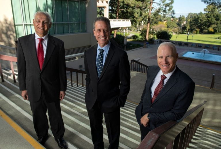 Pramod Khargonekar, vice chancellor for research, left, with Dr. Michael Stamos, dean of the School of Medicine, center, and Frank LaFerla, dean of the School of Biological Sciences, right.