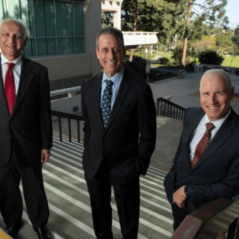 Pramod Khargonekar, vice chancellor for research, left, with Dr. Michael Stamos, dean of the School of Medicine, center, and Frank LaFerla, dean of the School of Biological Sciences, right.