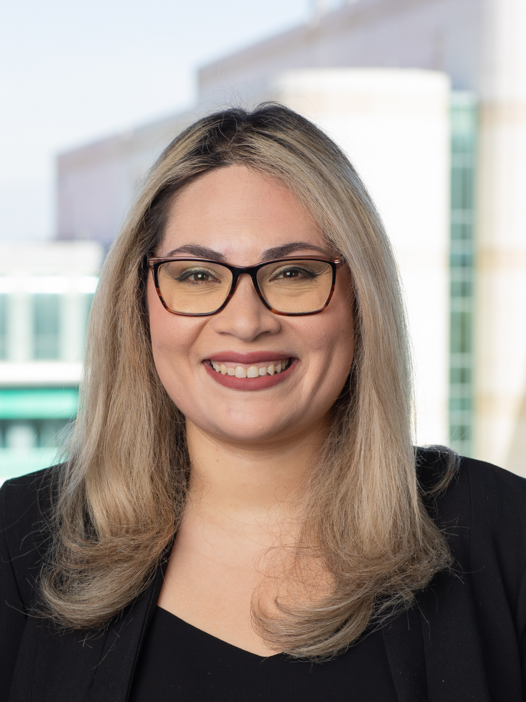 Headshot of Regina Castleman, the Marketing and Communications Manager at UC Irvine School of Biological Sciences, in front of McGaugh Hall.